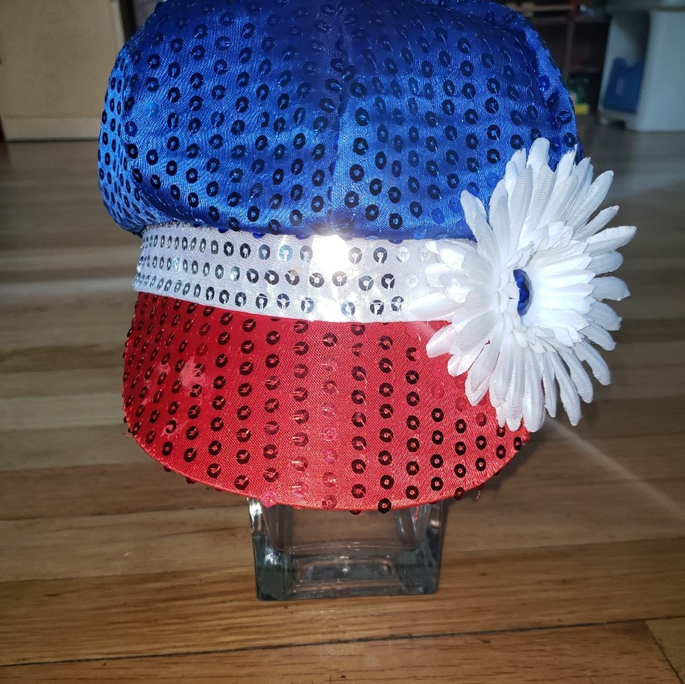 Red white and blue sparkly hat with flower